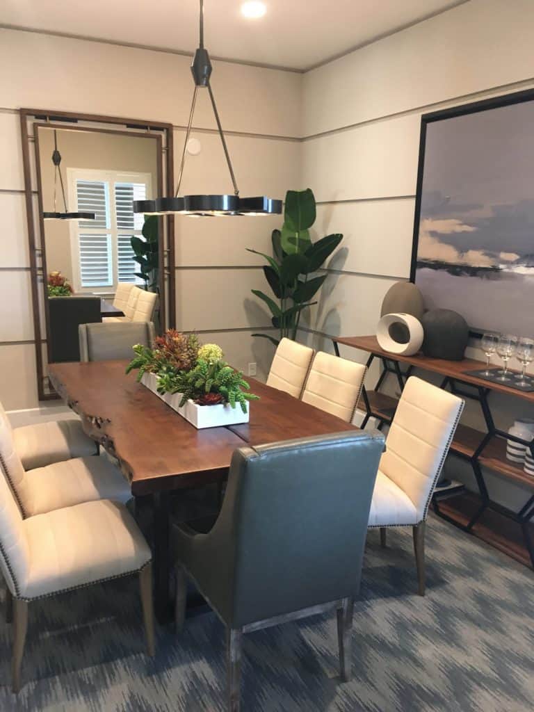 Elegant dining room with banana tree and succulent arrangement.