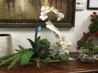 Silk White orchids and succulents in boat