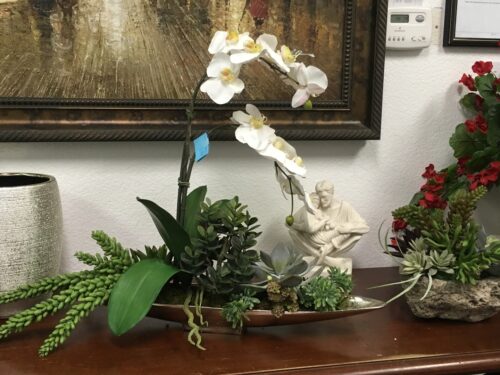 Silk White orchids and succulents in boat